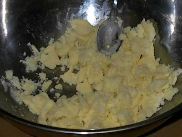 a mixing bowl of crumbled butter