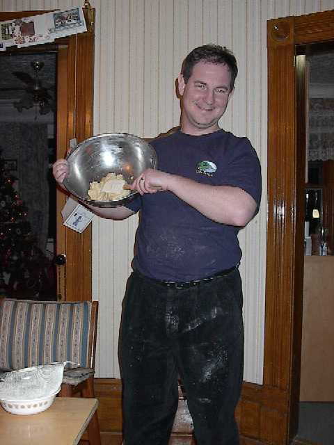 a photo of a man stirring pastry in a bowl